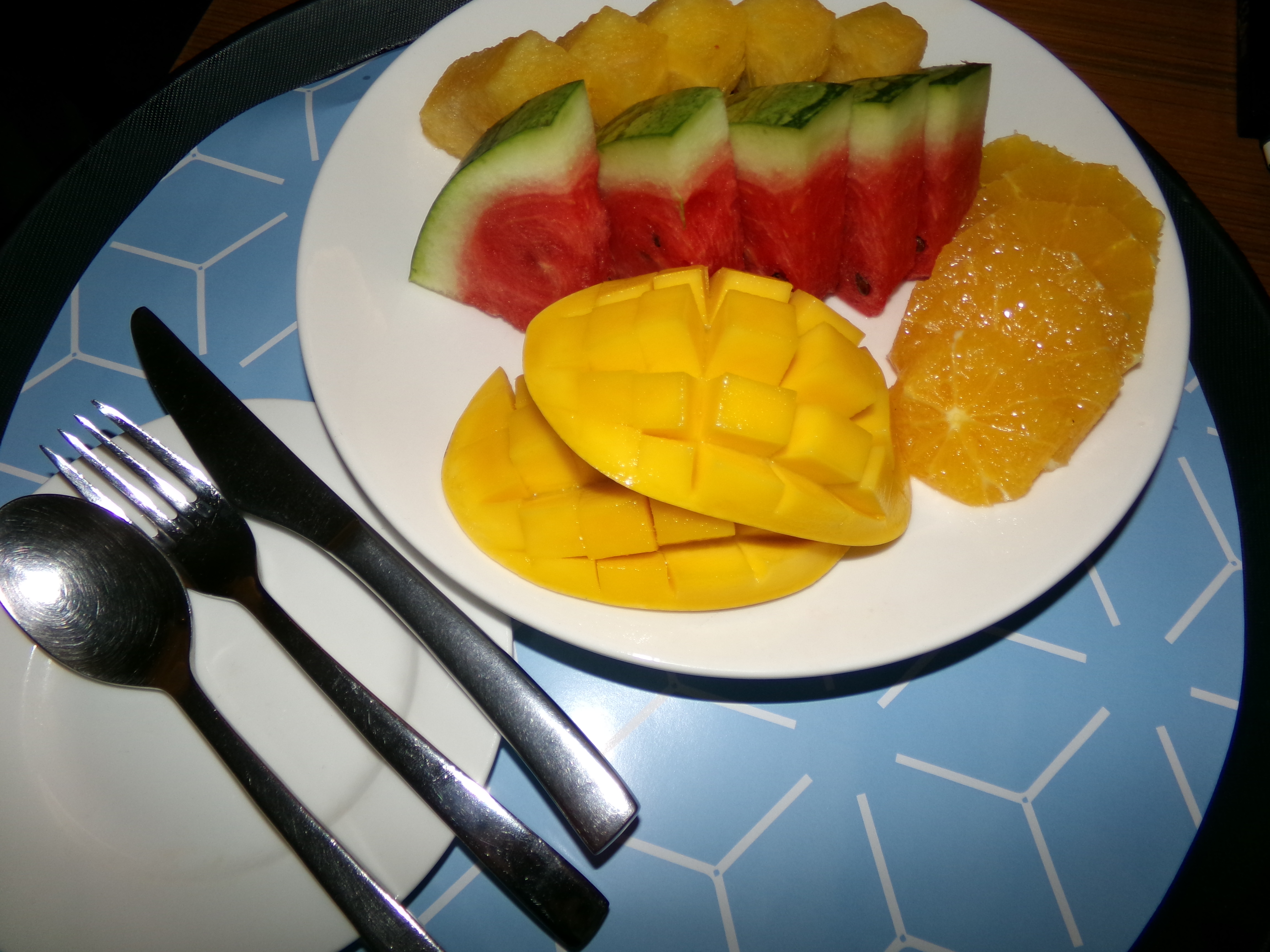 An image of various fruits such as sliced oranges, golden melon, watermelon and mango